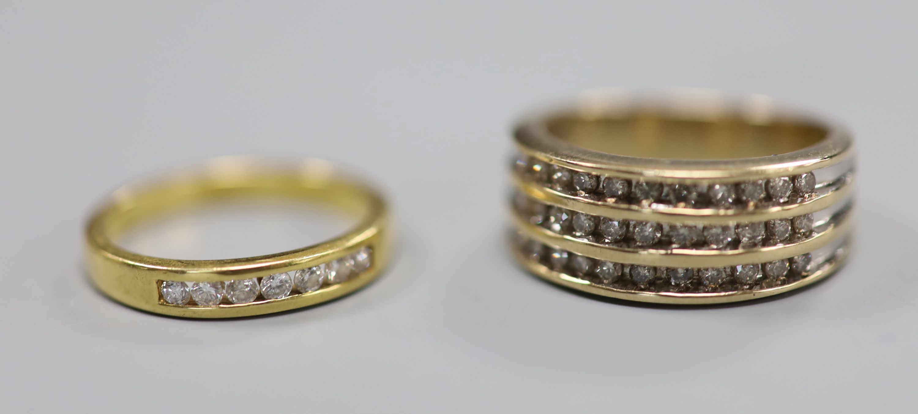 A 9ct gold and three row diamond chip set half hoop ring, size N/O and a 9ct and channel set seven stone diamond half eternity ring